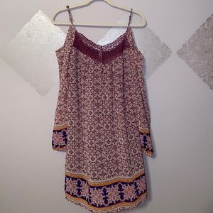 A patterned pink,purple,blue shoulder cut dress